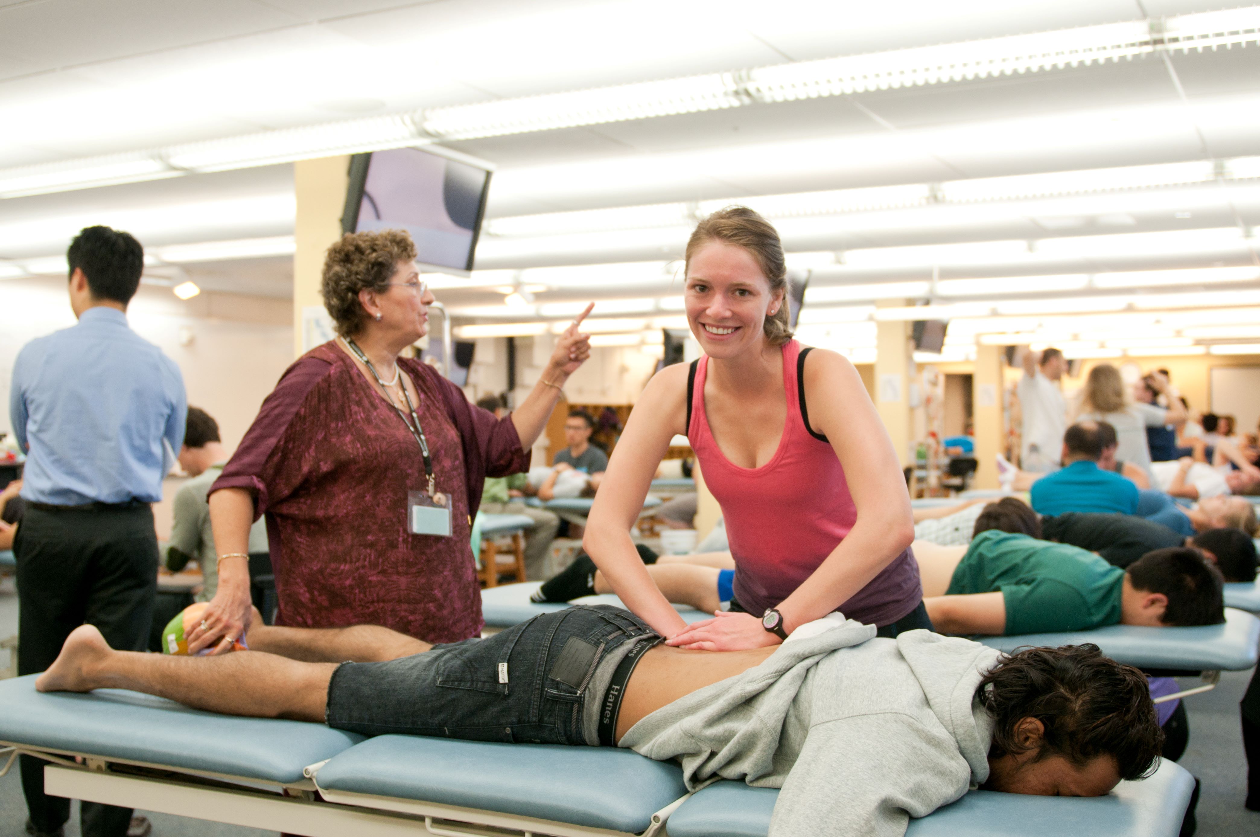 Student doctor practices osteopathy on a fellow student