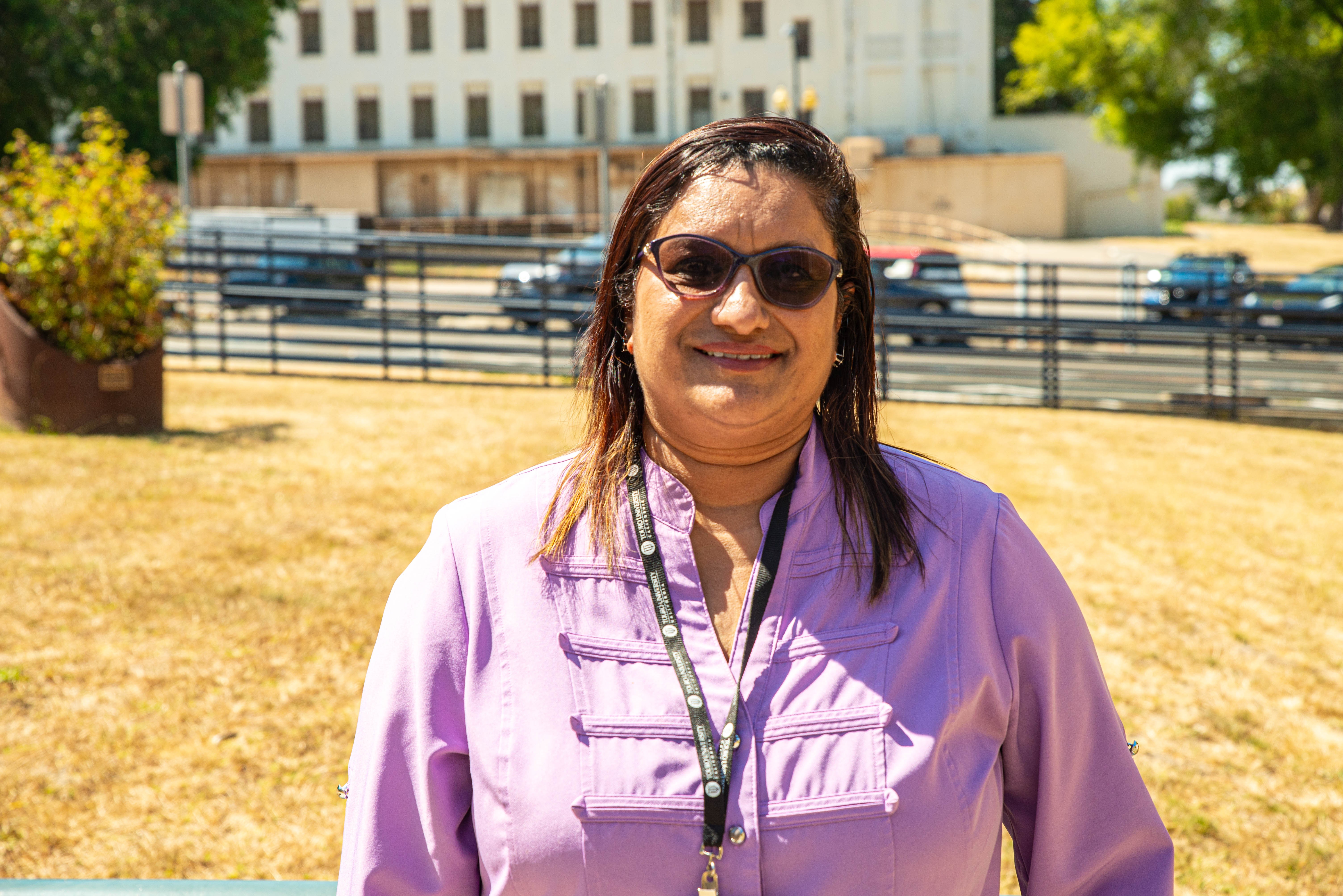  Dr. Chitra Pai  wearing a light purple shirt standing outside