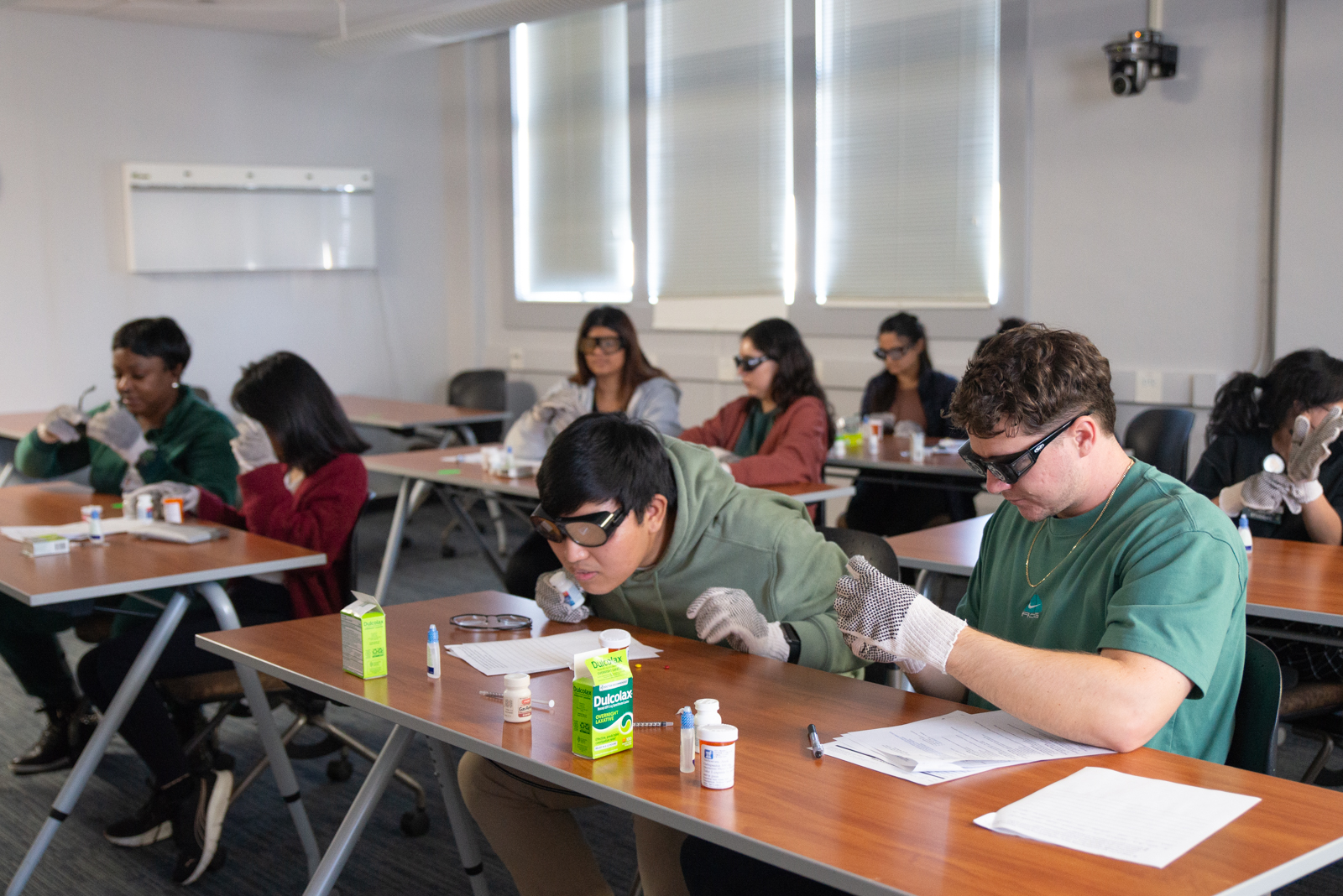 College of Pharmacy first year students participate in empathy training through the mock experiences of manual dexterity and visual impairment.