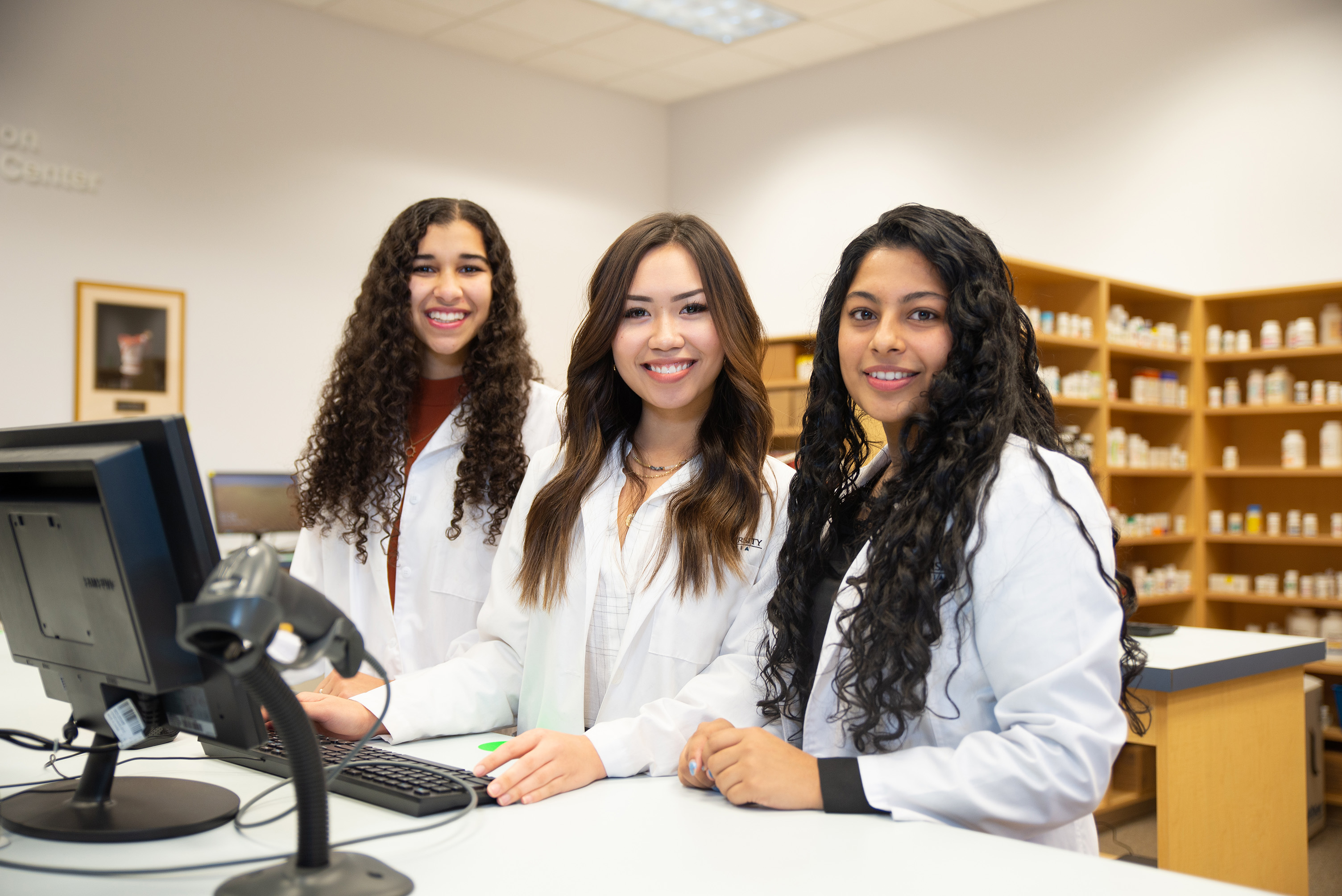 Group of pharmacists standing at a counter