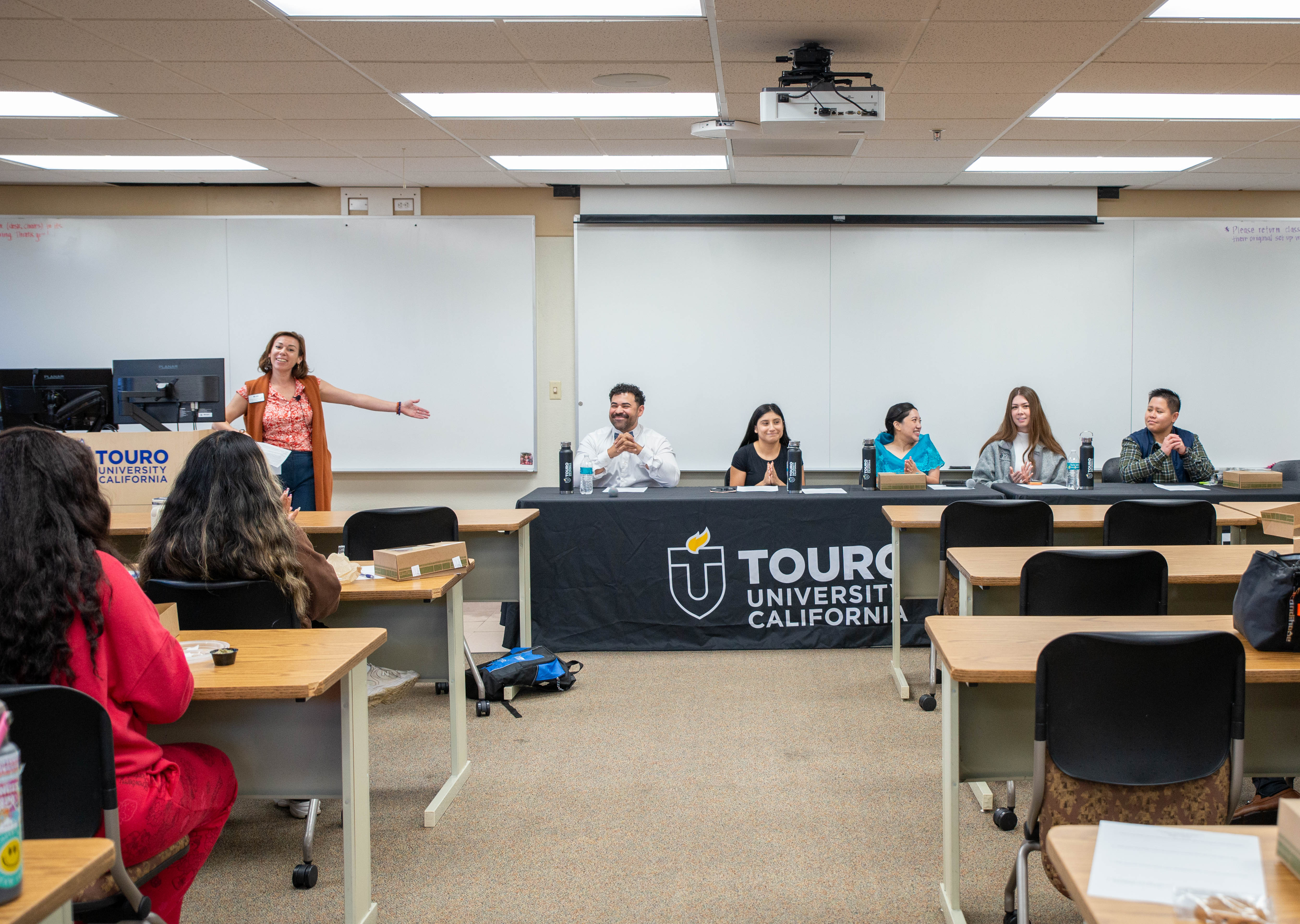 A photo shows Yvette Elizabeth Carrillo, Director of Student Activities, as she introduces students taking part in the &ldquo;Celebrating our Collective Voices in Health Care: Stories from our Latino and Filipino Communities&rdquo; panel discussion on campus, Oct. 28, 2025.