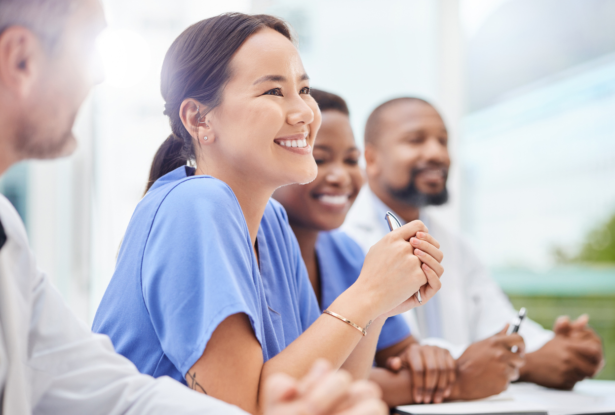 Student nurses sitting in a classroom facing a teacher that is out of view