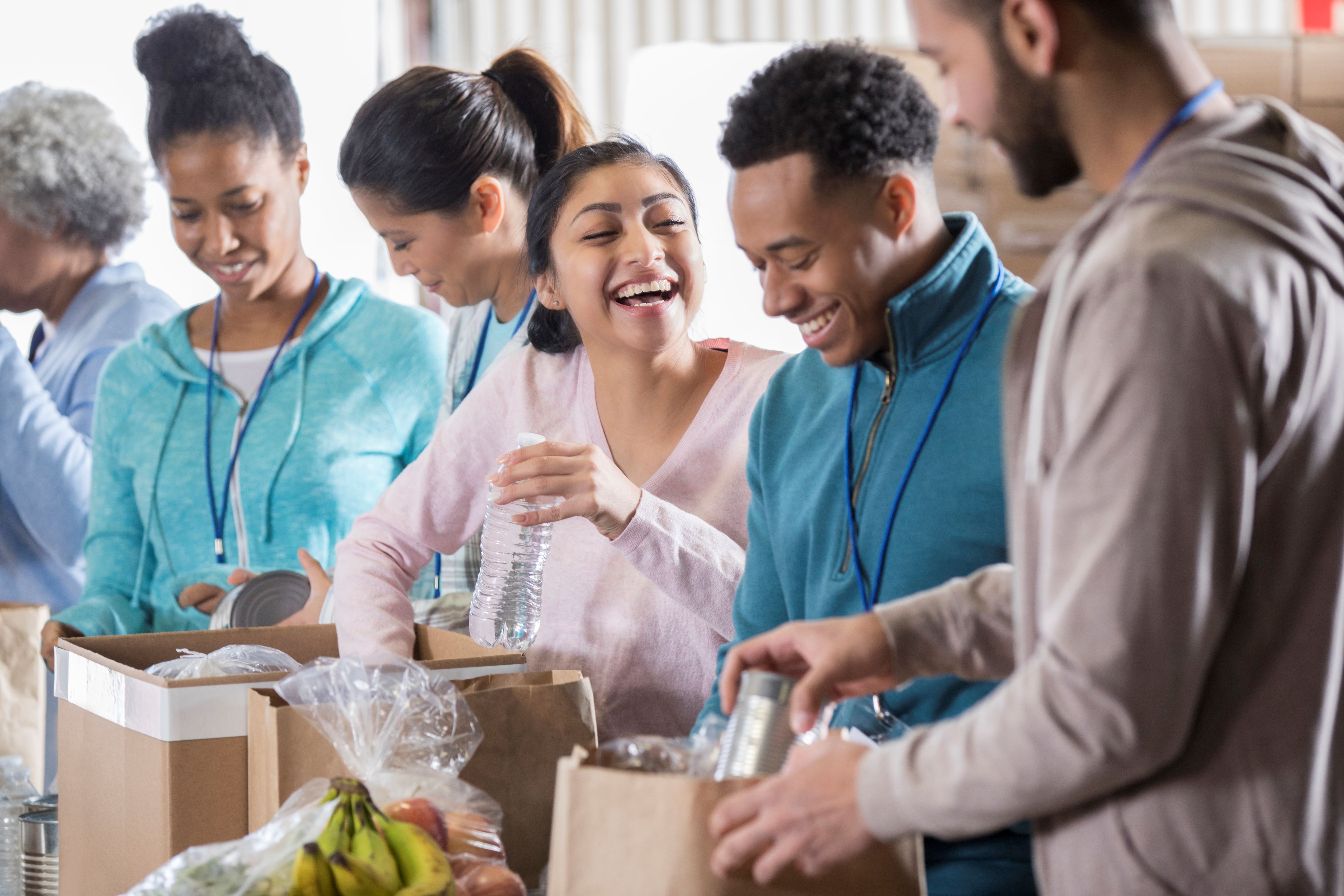 Students packing boxes full of food to feed hungry people