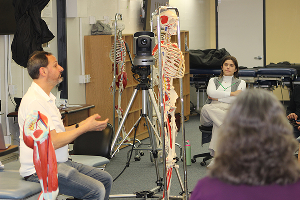 A photo shows Dr. Daniel Shadoan, left, as he gives a talk during the 6th Annual Integrative Medicine Symposium on the Touro University California campus, Sunday, Jan. 21, 2024.