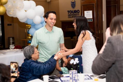 TUCOM student gathers with family after Match Day results.