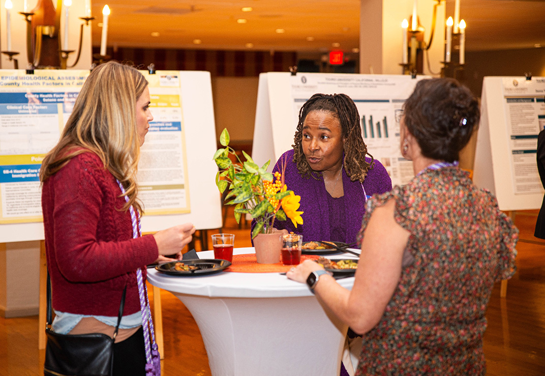 A photo shows Touro University California School of Nursing alumna Jennifer Tudor (Class of 2015, at left), School of Nursing former Director Jacqueline Clavo-Hall (center), and Nursing program alumna Jennifer Veler (Class of 2019, at right) as they visit during a School of Nursing Mixer and Poster Presentation in the Farragut Inn Ballroom on campus, Thursday, Oct. 26, 2023.