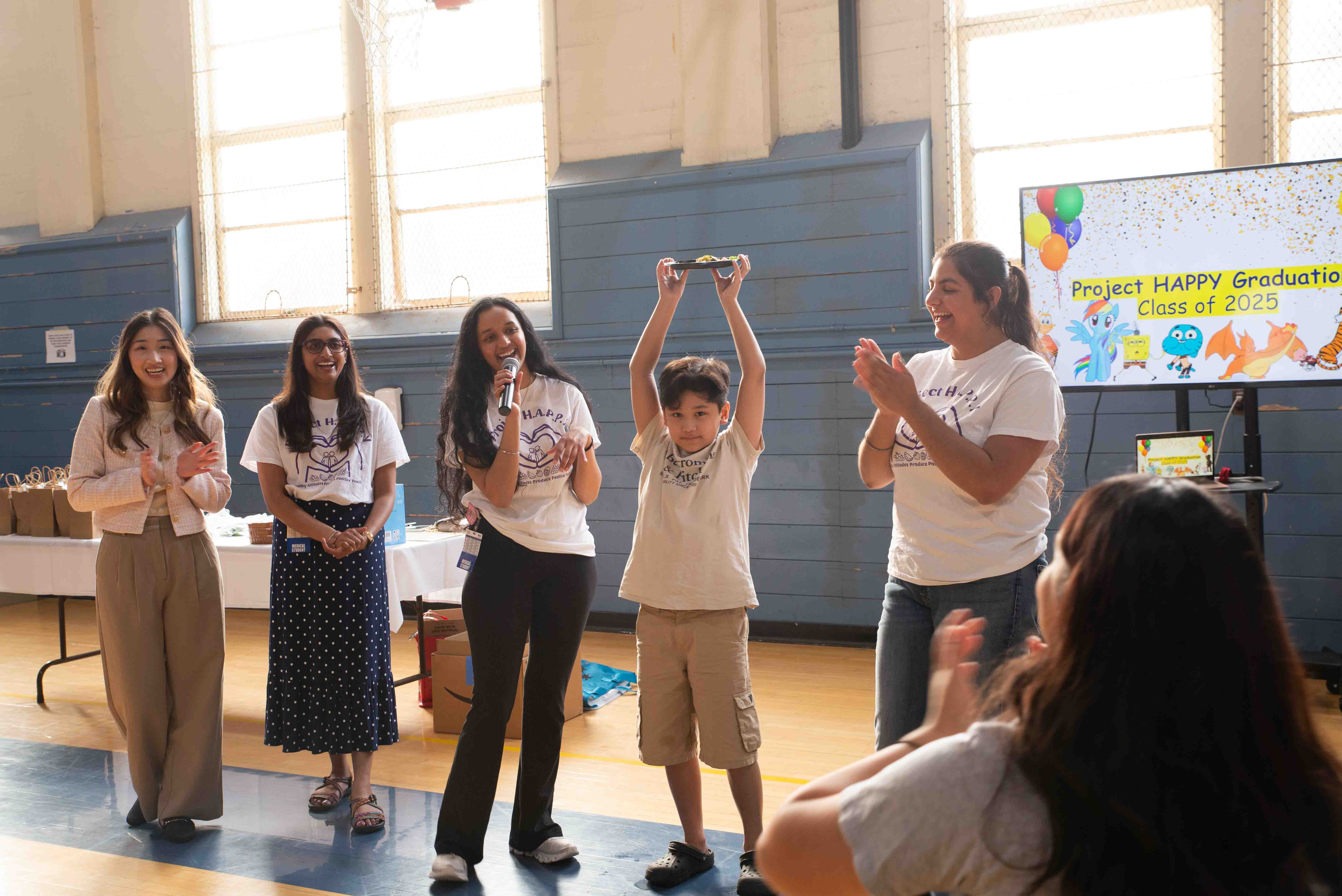 Students from College of Osteopathic Medicine and Project Happy celebrate graduation.