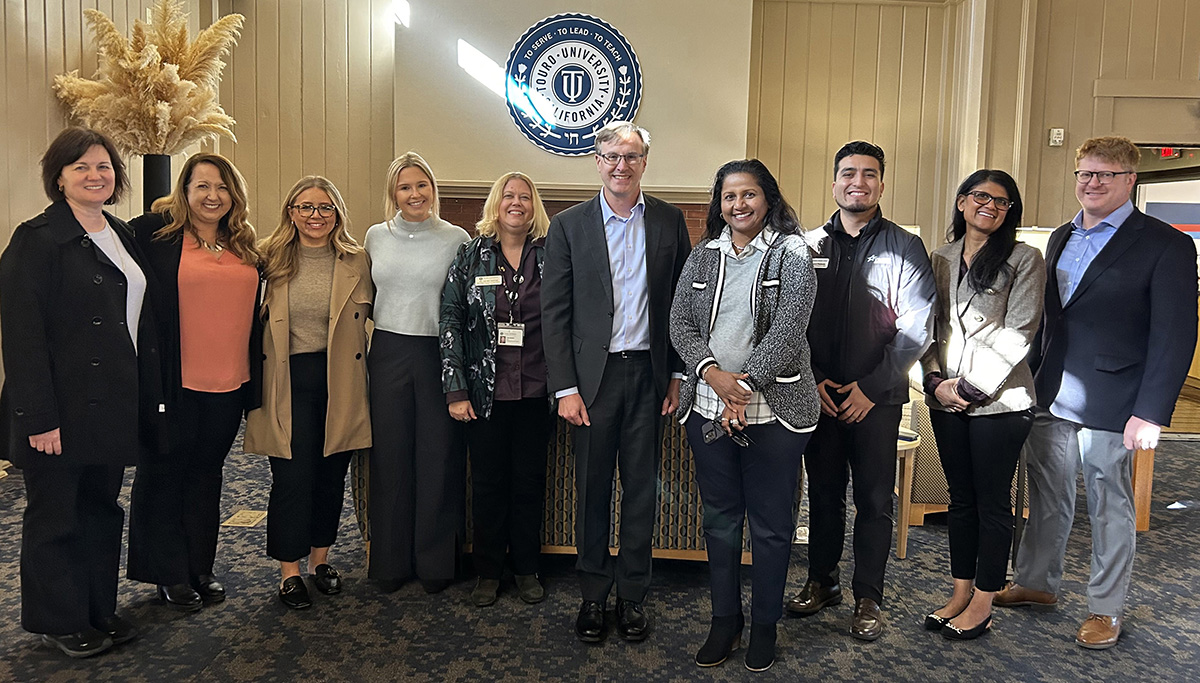 This photo shows Travis Credit Union-NorthBay Health Nursing Scholarship recipients Camryn Wentworth and Nora Fey along with Travis Credit Union Foundation Board of Directors Chairman Kevin Miller, other Travis Credit Union officials, Touro University California leaders and School of Nursing representatives during a campus tour, Monday, Nov. 27, 2023.