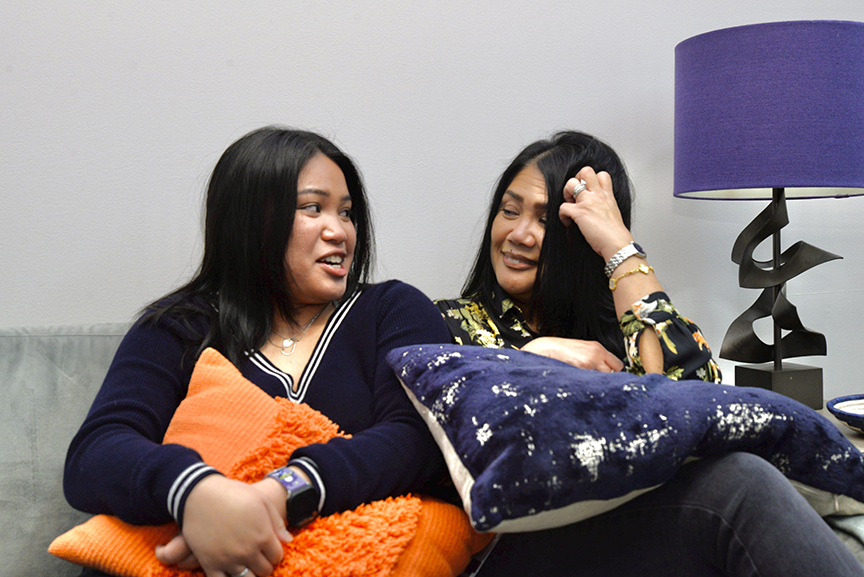 Iris and Joey Dreu pose for a photo while sitting on a couch.